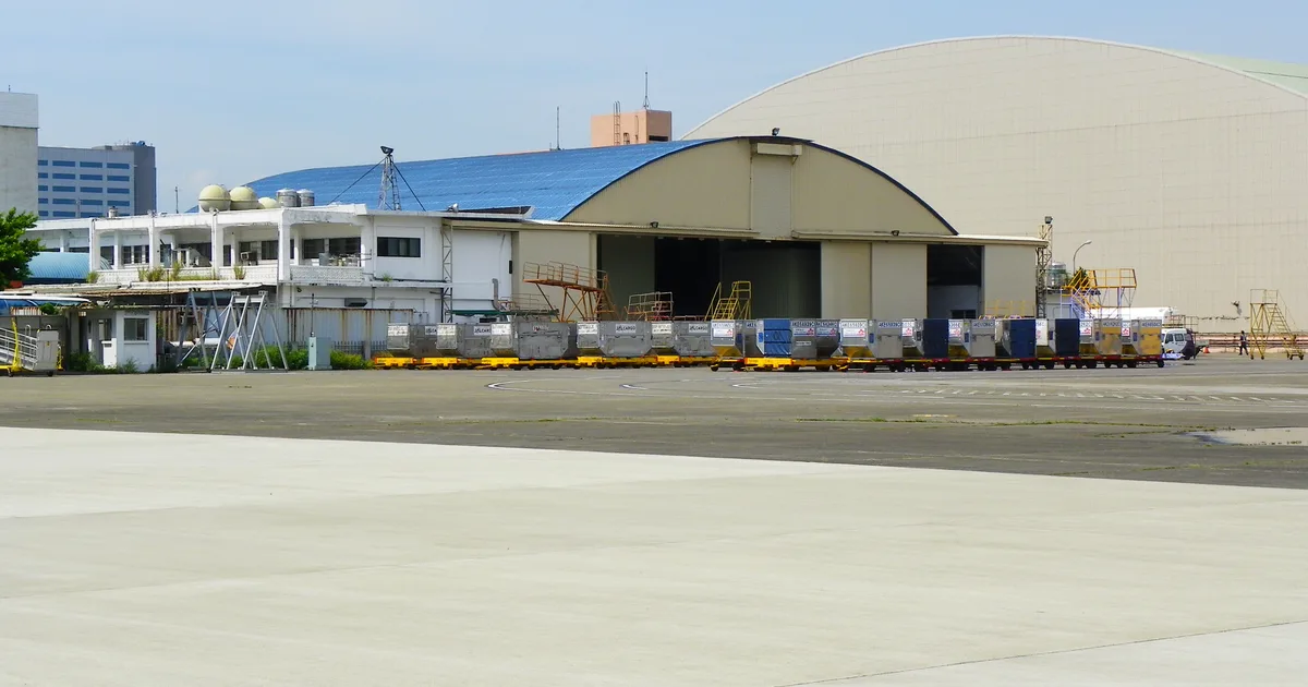 Air cargo containers lined up outside a freight warehouse