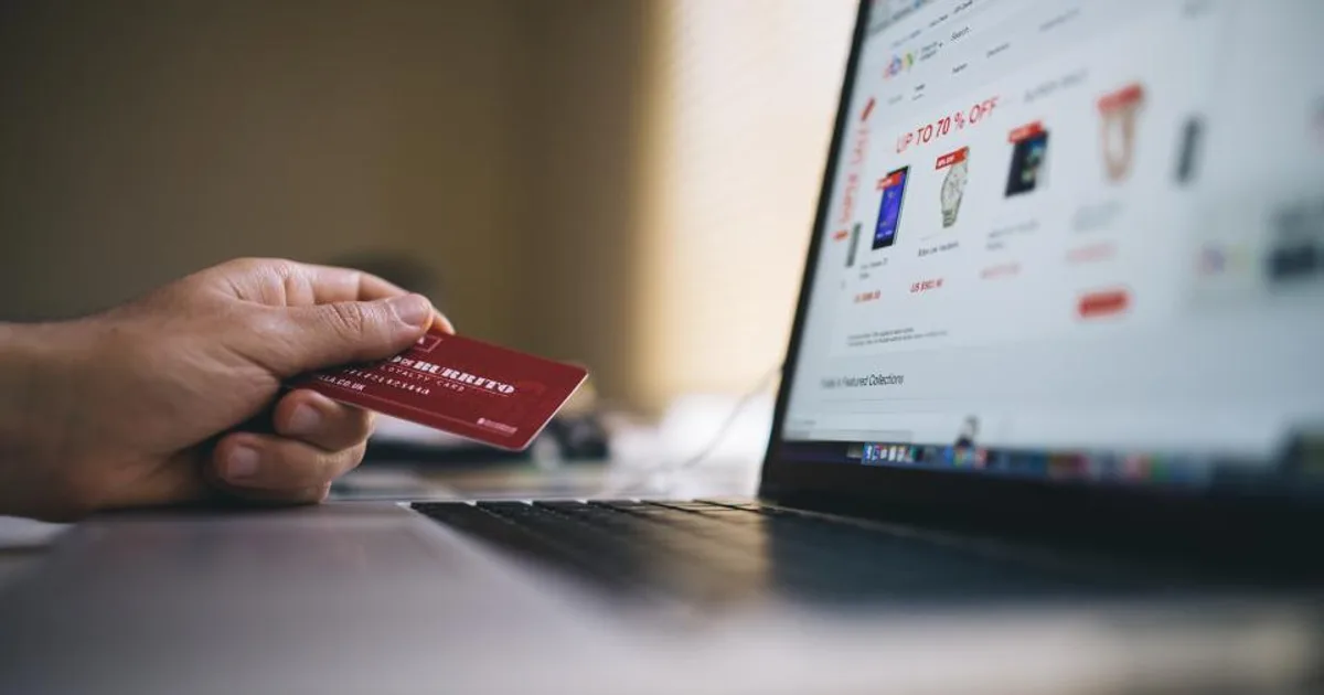 A customer paying by card on an online store, the transaction that becomes a payout line