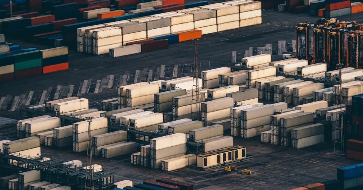 Shipping containers stacked in a terminal yard, where demurrage clocks run
